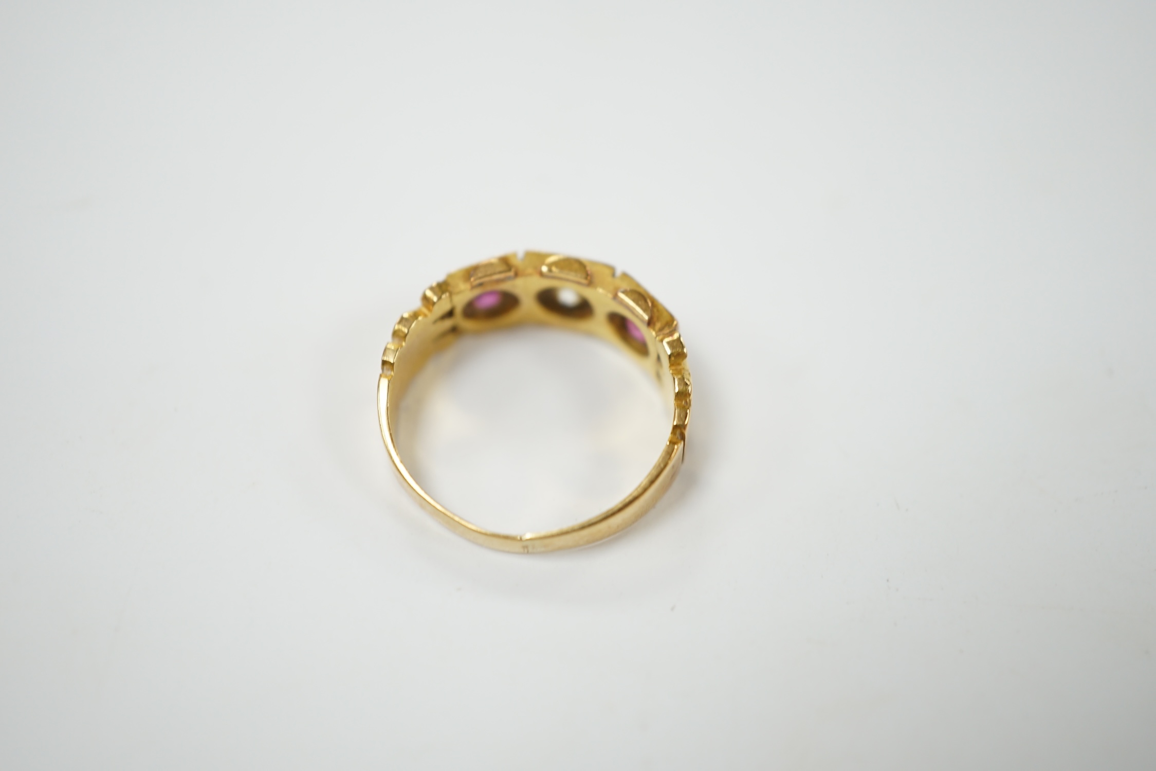 A late Victorian 18ct gold, ruby and diamond set three stone ring, size J, gross weight 4 grams. Condition - fair